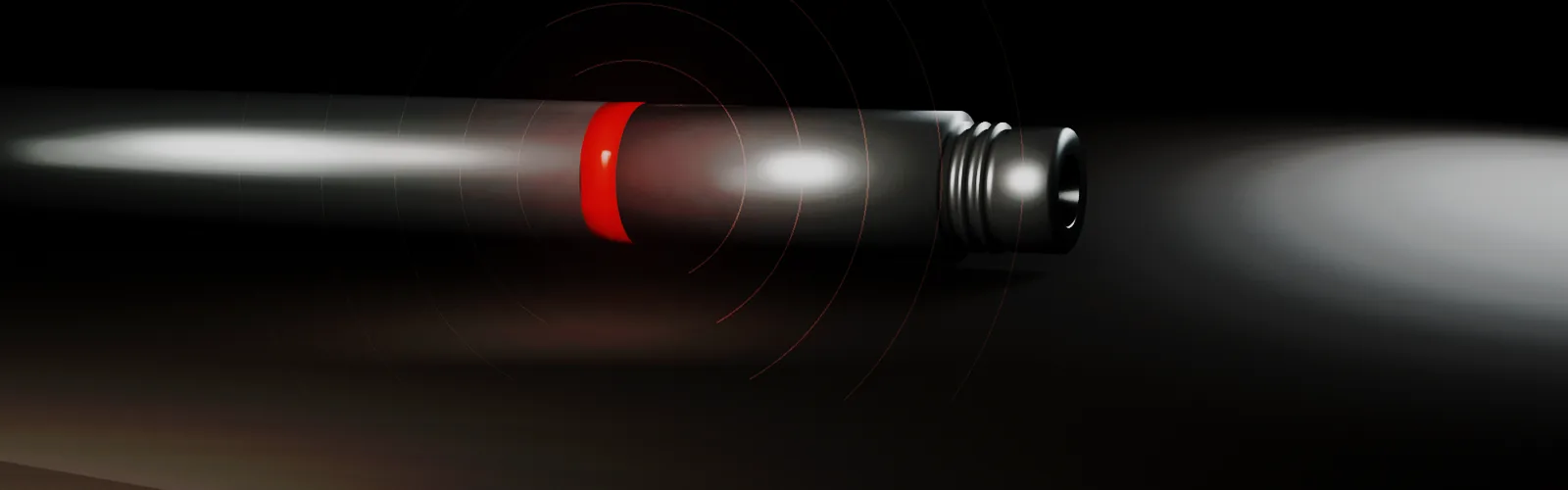 The WellFi tool on the tubing string in the dark, the signal spreading out from it in rings.